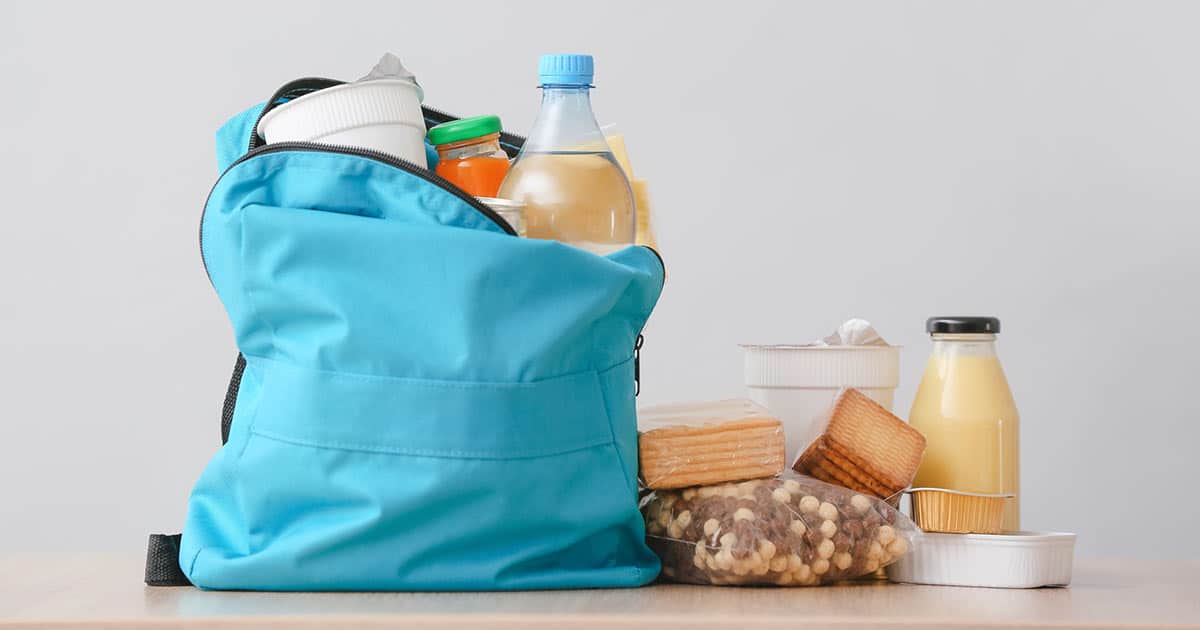 blue backpack filled and surrounded with food