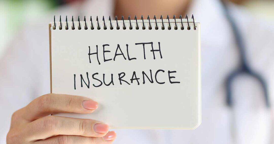 medical professional holding a note pad with health insurance written on it